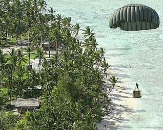 christmas-drop A Christmas supply box, dropped from a C-130E transport plane, floats toward one of the many Islands of Chuuk during a previous Operation Christmas Drop. (Pacific Daily News file photo)